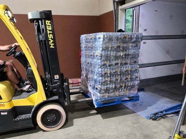 Forklift loading a wrapped pallet into a trailer at the NMV Expedition cross dock