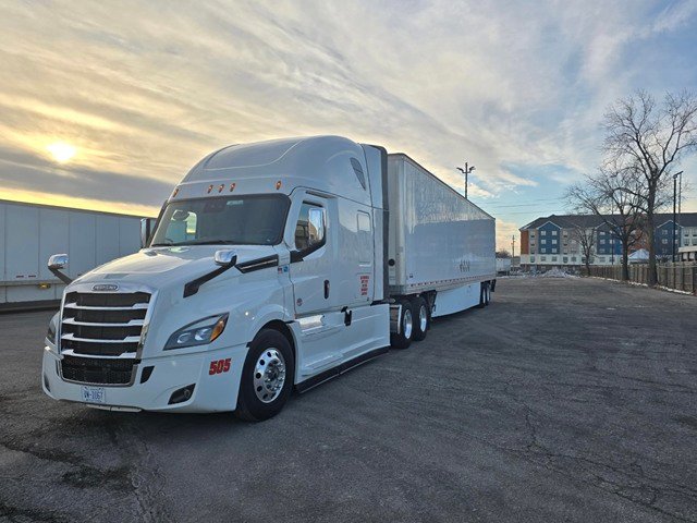 NMV Expedition Freightliner truck with dry van trailer at sunset
