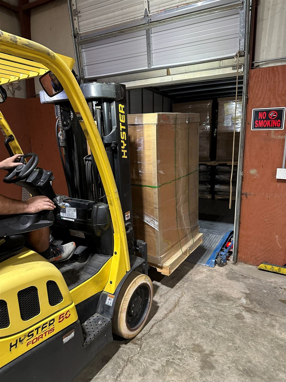 NMV Expedition forklift moving a reworked, shrink-wrapped pallet at the Pineville, NC dock