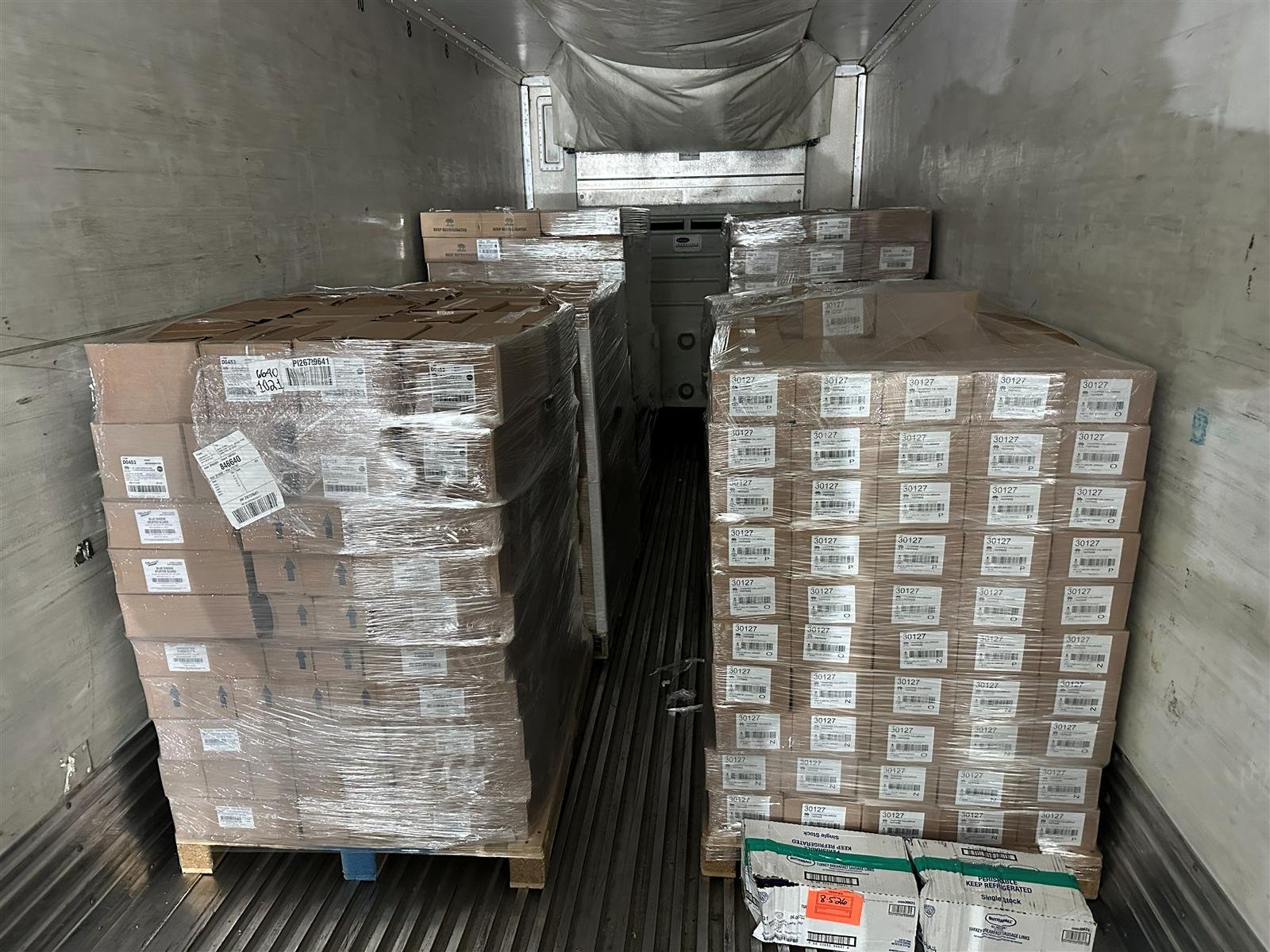 Rebuilt, labeled pallets staged inside a trailer at the NMV Expedition cross-dock in Pineville, NC